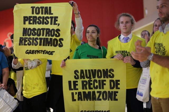 Greenpeace activists protest during Total's annual shareholders meeting, against the French oil and gas major's quest to the drill in the ecologically sensitive Amazon basin.