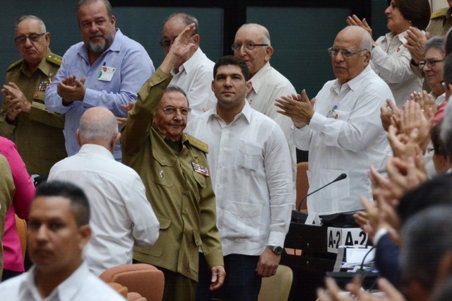 Cuba's former President Raul Castro waves as he arrives for the extraordinary session of Cuba's National Assembly in Havana.