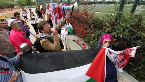Palestinian rights supporters protest at Argentina's football training session in Barcelona, Spain.