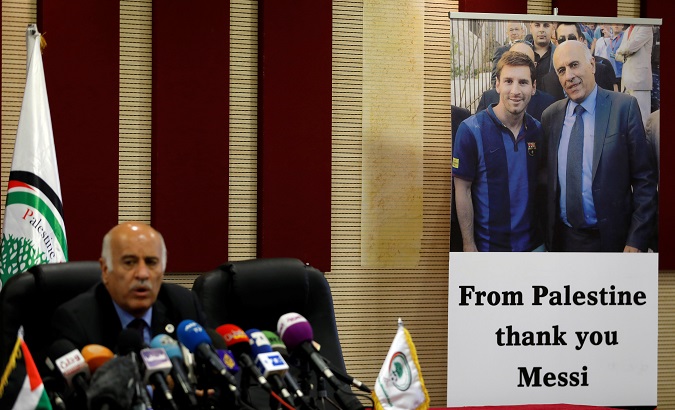 A poster of Palestinian FA chief Jibril Rajoub with Argentina's soccer player Messi is seen during Rajoub's news conference, in Ramallah, West Bank.