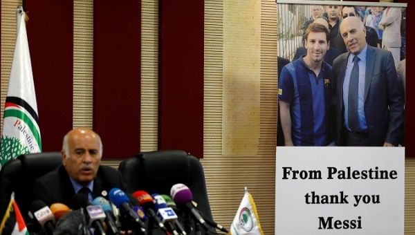 A poster of Palestinian FA chief Jibril Rajoub with Argentina's soccer player Messi is seen during Rajoub's news conference, in Ramallah, West Bank.