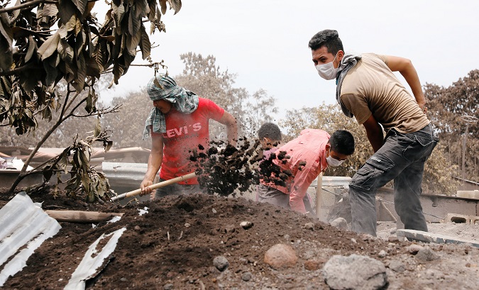 Residents shovel ashes in search of victims' remains in Guatemala following the deadly volcanic eruptions.