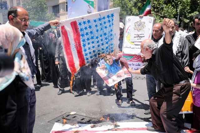Iraqi Muslims burn effigies during a parade marking the annual al-Quds Day in Tehran, Iran.