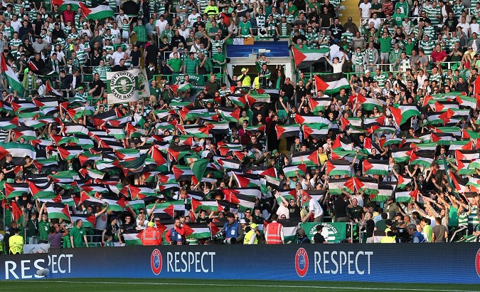 Celtic FC fans fly Palestinian flags in solidarity with Palestine.
