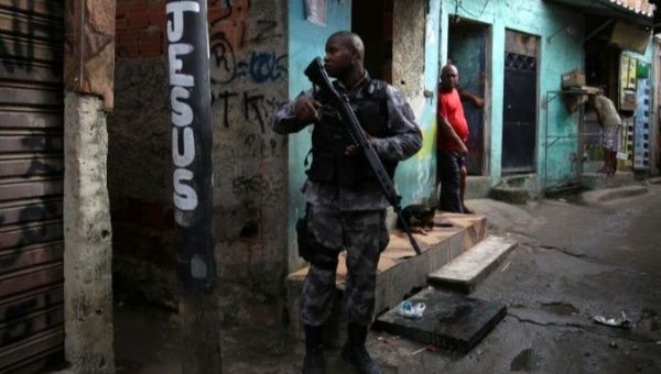 A military policeman patrols the Kelson favela during an operation in Rio de Janeiro, Brazil.
