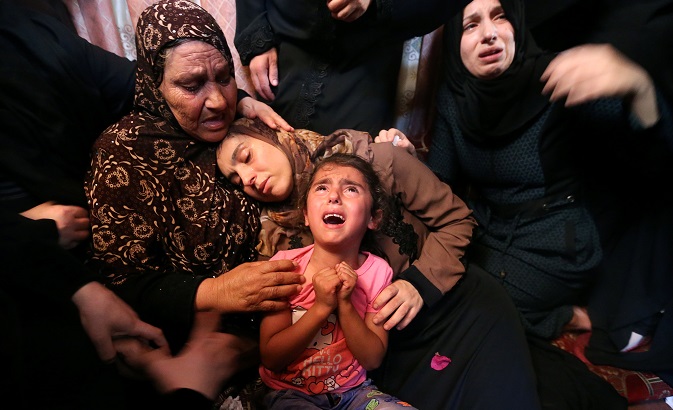 Relatives of Palestinian Haytham Al-Jamal, 15, mourn during his funeral in Rafah in the southern Gaza Strip.