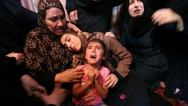 Relatives of Palestinian Haytham Al-Jamal, 15, mourn during his funeral in Rafah in the southern Gaza Strip.