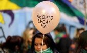 A demonstrator holds a baloon that reads "Legal abortion now" during a protest against femicides and violence against women in Buenos Aires, Argentina, June 4, 2018.