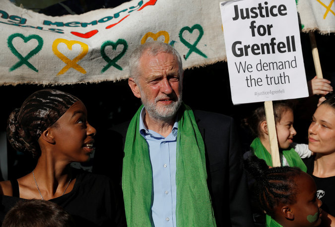 Britain's opposition leader Jeremy Corbyn meets with residents before joining the Silent March.
