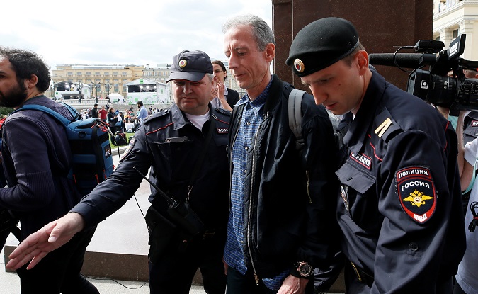 Veteran British LGBT rights campaigner Peter Tatchell is detained by police officers in central Moscow, Russia, June 14, 2018.