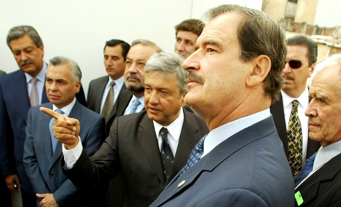 File Photo: Mexico City mayor Andres Manuel Lopez Obrador (C) points as Mexican President Vicente Fox (R) listens during a tour of a project to rejuvenate the capital's city center May 29, 2003.