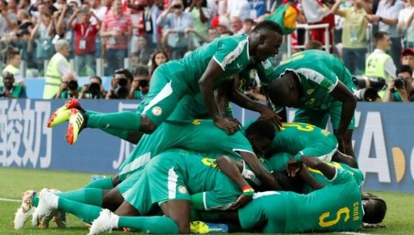 Senegal's M'Baye Niang celebrates scoring their second goal with teammates.