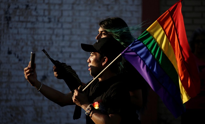 Members of the LGBT community carry a rainbow flag during a march in support of gay marriage, sexual and gender diversity in Ciudad Juarez, Mexico, June 10 2018.