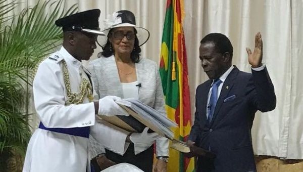 Cécile La Grenade, center, the Governor-General of Grenada, swears in Dr. Keith Mitchell, right, as the Prime Minister of Grenada in March.