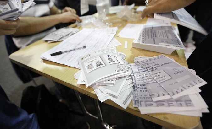 Officials count ballots in Colombia's presidential elections, which have been marred by allegations of fraud.