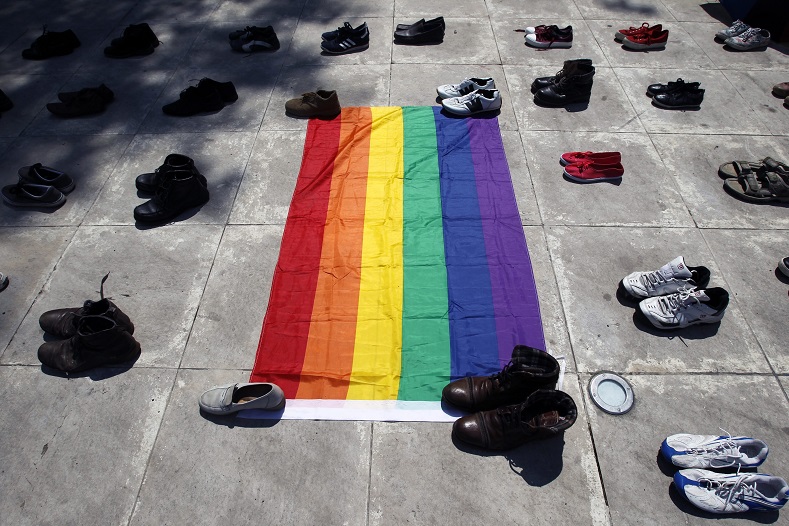 Pairs of shoes belonging to members of Romania's LGBT+ community are arranged around a rainbow-colored flag at a rally in downtown Bucharest, Romania, 22 May 2016, the country’s 12th annual LGBT event. The event is organized to raise awareness about the so-called 'invisible' members of the LGBT+ community in Romania.