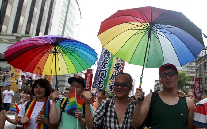Participants hold rainbow umbrellas during a rally to demanding the Taiwanese government to legalize same-sex marriage in front of the ruling Nationalist Kuomintang Party headquarters in Taipei, Taiwan, July 11, 2015.