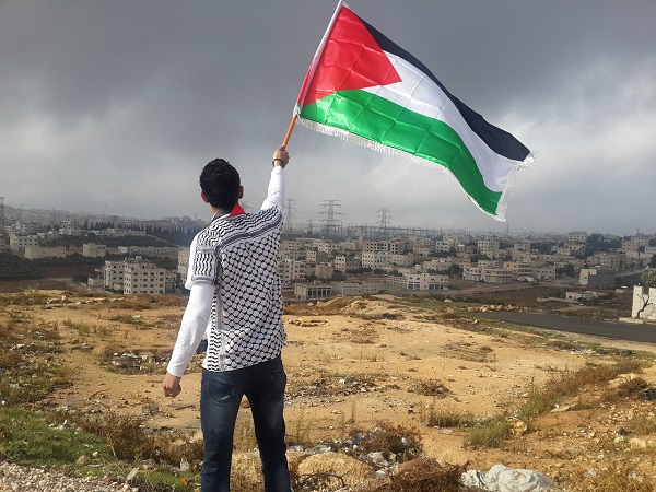 A man waves a Palestinian flag.