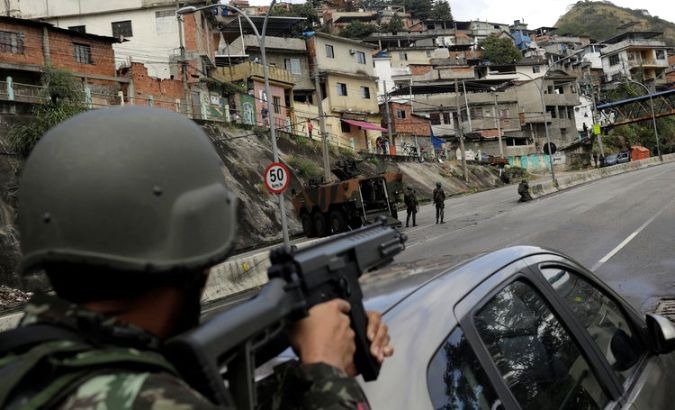 Brazilian soldiers take position in the Lins Favela Complex in Rio de Janeiro.