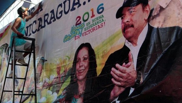 A man hoists a banner in support of Nicaragua's President Daniel Ortega.