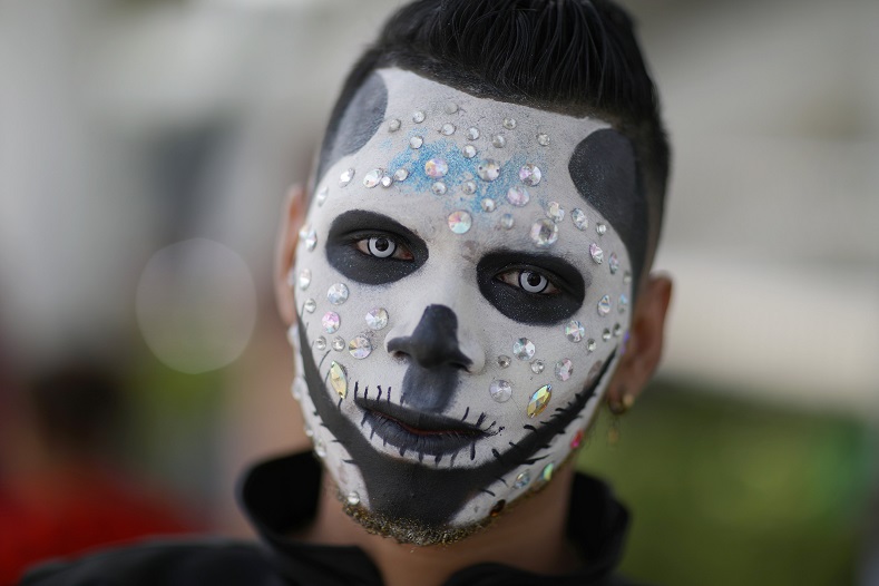 A magnificently made-up participant attends the Gay Pride parade in San Salvador, El Salvador, June 30, 2018.