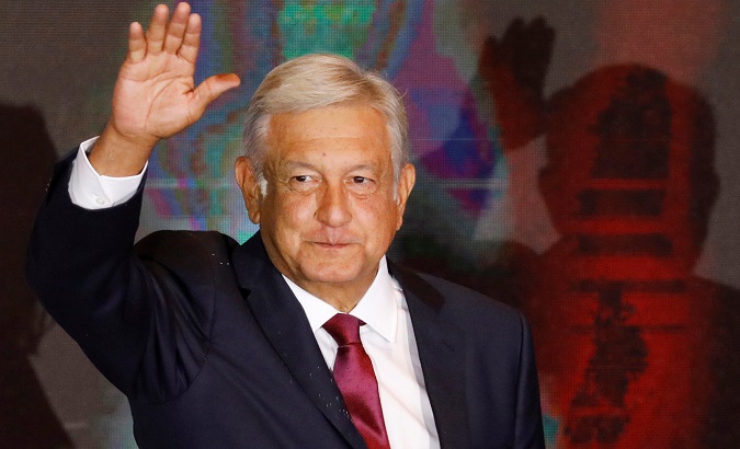 Presidential candidate Andres Manuel Lopez Obrador waves as he addresses supporters after polls closed in the presidential election, in Mexico City.