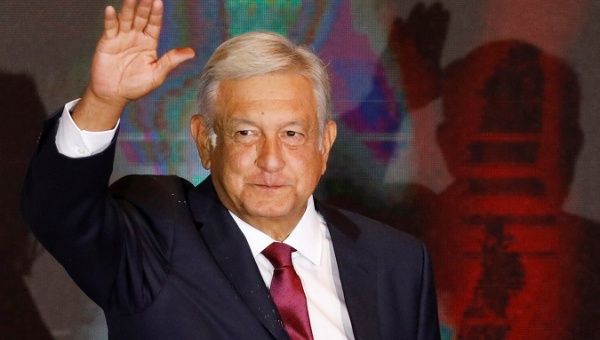 Presidential candidate Andres Manuel Lopez Obrador waves as he addresses supporters after polls closed in the presidential election, in Mexico City.