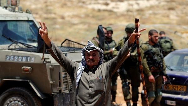 A Palestinian man gestures during a protest against a new Jewish settlement outpost near Hebron in the occupied West Bank, June 26, 2018.