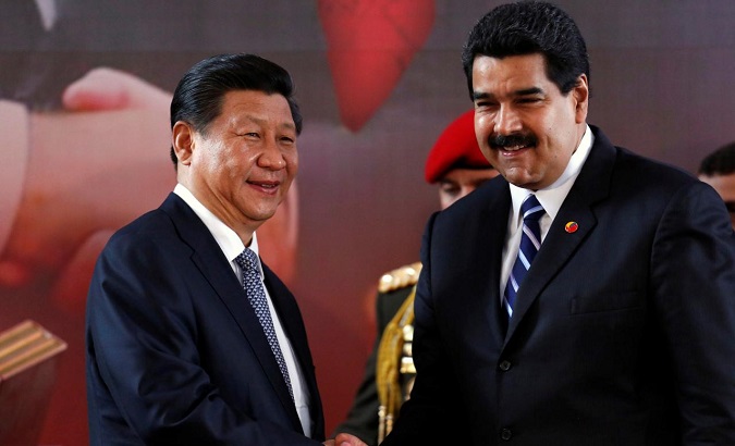 China's President Xi Jinping (L) and Venezuela's President Nicolas Maduro shake hands during a signing ceremony in Caracas July 21, 2014.