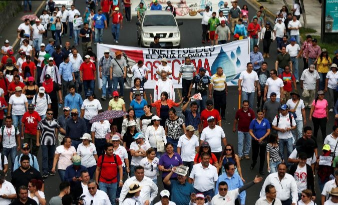 People participate in a protest against privatisation of water in San Salvador.