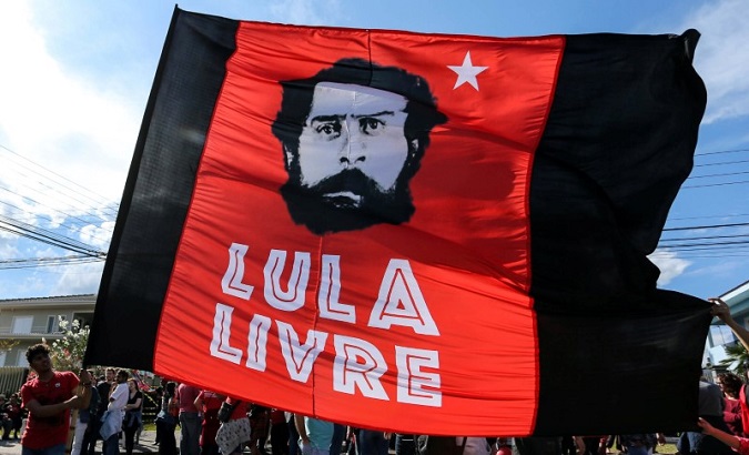 Supporters of former Brazilian President Luiz Inacio Lula da Silva hold a flag next to Federal police headquarters in Curitiba, Brazil, July 8, 2018. The flag reads: 