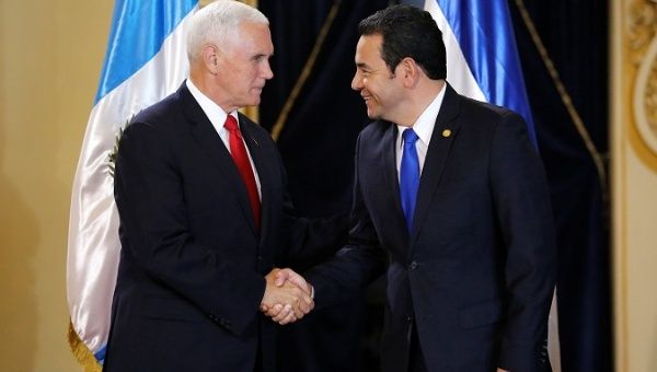 U.S. Vice President Mike Pence shakes hands President Jimmy Morales before a meeting at the National Palace of Culture in Guatemala City, Guatemala June 28, 2018.