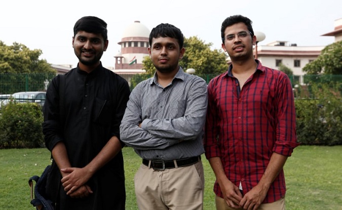 Anwesh Pokkuluri, Romel Barel and Krishna Reddy M, petitioners challenging Section 377 of the Indian Penal Code that criminalises homosexuality, pose outside the premises of the Supreme Court in New Delhi, India, July 10, 2018.