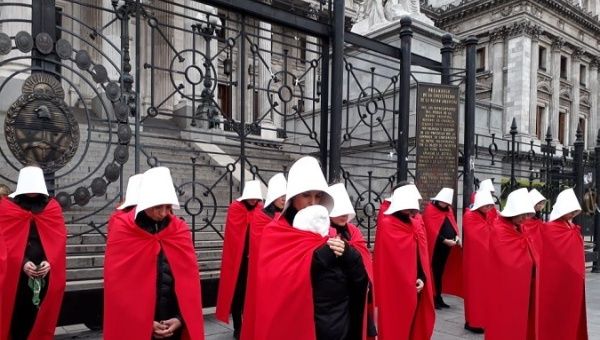 Women in Argentina hold symbolic protest outside the senate to demand legal abortions.