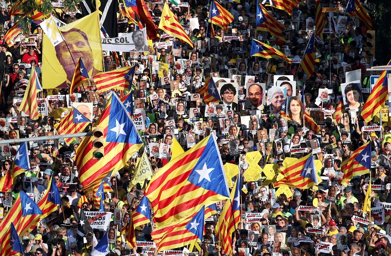 People raise banners of red, yellow and blue during a protest against the imprisonment of the Catalan independentist leaders, in Barcelona, Spain, July 1..