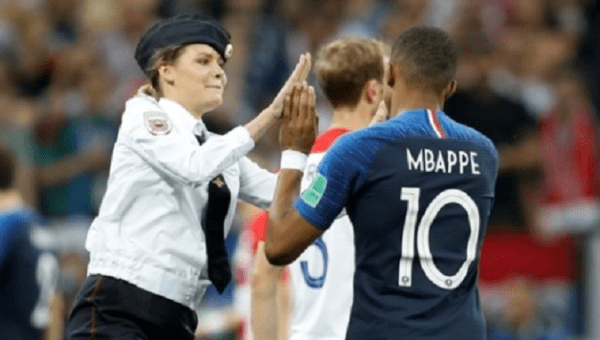 One photograph on social media showed one of the pitch invaders, a woman with blonde hair tucked under a police cap, performing a high-five with France player Kylian Mbappe before being caught.