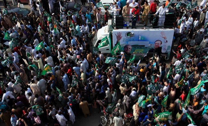 Supporters of PML-N chant march towards the airport to welcome ousted Prime Minister Nawaz Sharif and his daughter Maryam, in Lahore