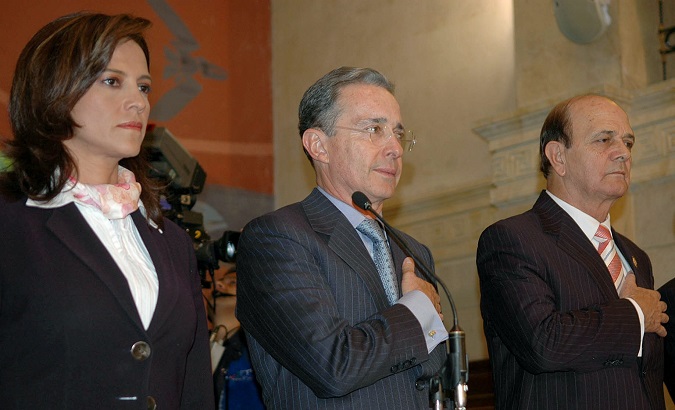 Former president of the Senate Nancy Patricia Gutierrez stands next to former president Alvaro Uribe during an official event in Congress.