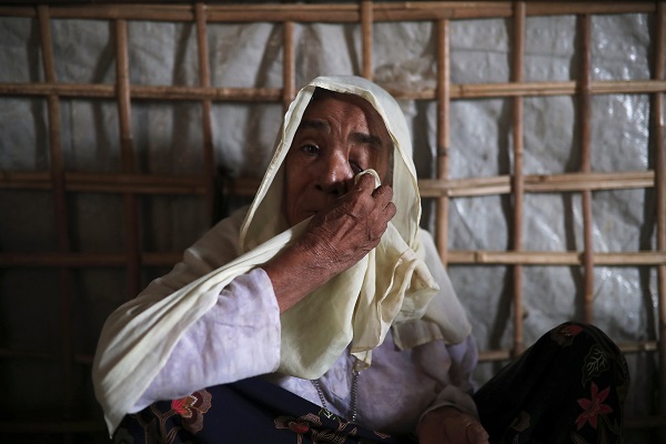 Roshan Begum, a Rohingya refugee, wipes her eyes after hearing the news that her son has been found in Buthidaung prison in Myanmar.