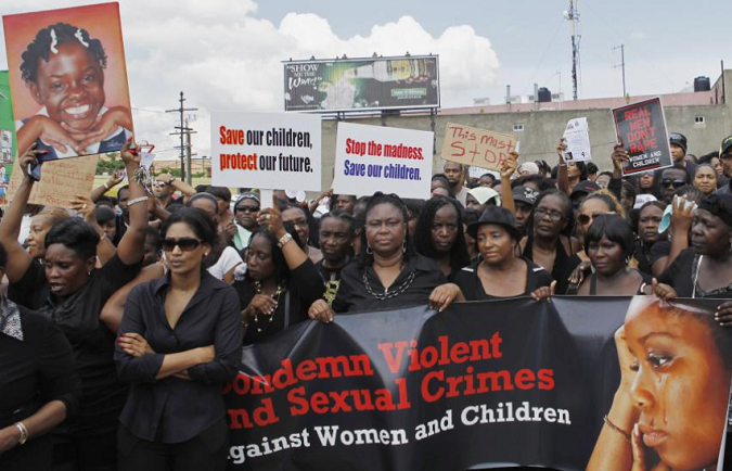 Jamaicans take part in a demonstration against the rape of three children and two women in Kingston on September 28, 2012.