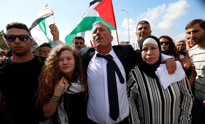 Palestinian teenager Ahed Tamimi and her mother walk out after they were released from an Israeli prison, at Nabi Saleh village in the West Bank July 29, 2018.