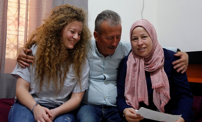 Palestinian teenager Ahed Tamimi sits next to her father and her mother Nareman, at their family house in Nabi Saleh village in the occupied West Bank July 30, 2018.