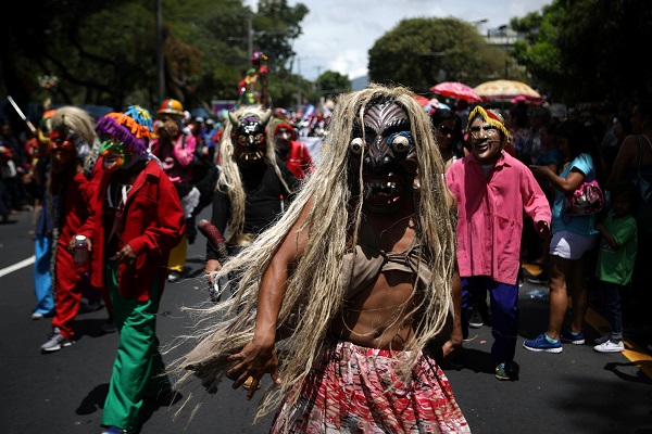 The revellers wear masks and dress up as characters from Salvadoran folk tales.