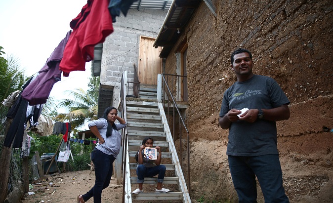 Douglas Almendarez, 37, a deportee from the U.S. who was separated from his son Eduardo Almendarez, 11, at the Rio Grande entry point speaks next to his wife Evelin Meyer, and Marcela, 9, his daughter, in Olancho state Honduras July 14, 2018