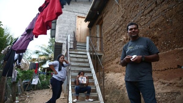 Douglas Almendarez, 37, a deportee from the U.S. who was separated from his son Eduardo Almendarez, 11, at the Rio Grande entry point speaks next to his wife Evelin Meyer, and Marcela, 9, his daughter, in Olancho state Honduras July 14, 2018