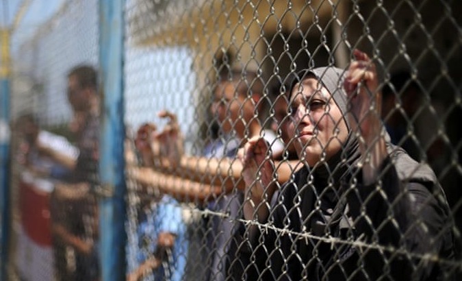 Palestinians gather in front of the gate of Rafah border crossing between Egypt and Gaza during a protest against the blockade calling for reopening of the crossing.