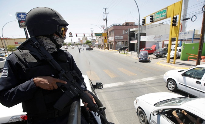 A state police patrols the streets as he and his team reinforce security in Ciudad Juarez.