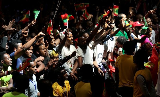 People hold Oromo Liberation Front flags.