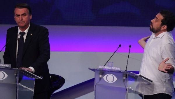 Jair Bolsonaro (L) and Guilherme Boulos (R) participate in Brazil's presidential debate.