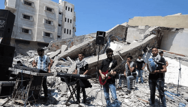 Palestinian musicinas perform on the ruins of Gaza's Said al-Mishal Cultural Center.